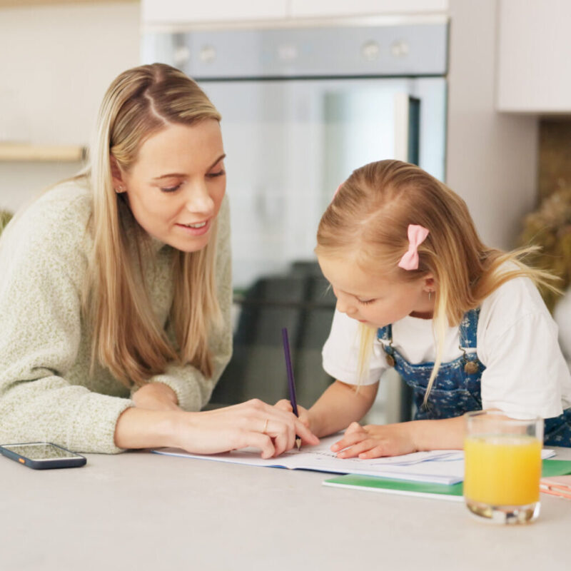 Education, mother and girl writing in kitchen for school task, assignment or homework. Help, learni.